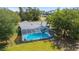 Aerial view of a screened-in pool featuring deck area and glimpses of an adjacent backyard at 5220 Sw 161St Place Rd, Ocala, FL 34473