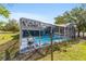 Backyard pool with screened-in enclosure featuring a bright outdoor space at 5220 Sw 161St Place Rd, Ocala, FL 34473