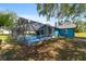A large screened pool enclosure enhances backyard fun with space for furniture and swimming at 5220 Sw 161St Place Rd, Ocala, FL 34473