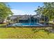 Exterior view of the home featuring an enclosed pool for enjoyment and relaxation at 5220 Sw 161St Place Rd, Ocala, FL 34473