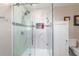 Modern shower with glass doors, marble tile surround, and a built-in niche for toiletries at 5220 Sw 161St Place Rd, Ocala, FL 34473
