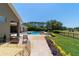 Landscaped backyard with colorful flowers, healthy green grass and a view of the covered patio at 5484 Sw 30Th Ave, Ocala, FL 34471
