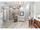 Bathroom featuring mosaic shower tile, chandelier, and wainscoting at 5484 Sw 30Th Ave, Ocala, FL 34471