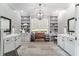 Dual-vanity bathroom with a bench, chandelier, and built-in storage at 5484 Sw 30Th Ave, Ocala, FL 34471