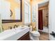 Bathroom features a modern sink, dark wood cabinets, and shower with an orange curtain at 5484 Sw 30Th Ave, Ocala, FL 34471