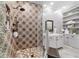 Bathroom featuring mosaic tiled shower and vanity at 5484 Sw 30Th Ave, Ocala, FL 34471