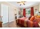 Cozy bedroom features hardwood floors, a window view, and neutral tones at 5484 Sw 30Th Ave, Ocala, FL 34471