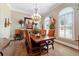 Elegant dining room featuring hardwood floors, a chandelier, and large windows at 5484 Sw 30Th Ave, Ocala, FL 34471
