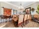 Cozy dining area showcasing a rustic table, upholstered chairs, and a decorative chandelier at 5484 Sw 30Th Ave, Ocala, FL 34471