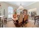 A formal dining room with a chandelier and arched windows illuminating the space at 5484 Sw 30Th Ave, Ocala, FL 34471