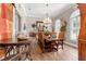 Formal dining room with hardwood floors, a chandelier, elegant seating, and natural light for memorable gatherings at 5484 Sw 30Th Ave, Ocala, FL 34471