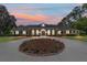 Charming home with a circular driveway highlighted by a colorful sunset at 5484 Sw 30Th Ave, Ocala, FL 34471