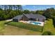 Beautiful home with a backyard pool, a patio with outdoor seating and fire pit surrounded by a black metal fence at 5484 Sw 30Th Ave, Ocala, FL 34471