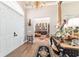 Elegant foyer features a chandelier, a mirror, and hardwood floors that transition seamlessly into adjacent living spaces at 5484 Sw 30Th Ave, Ocala, FL 34471