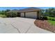 Attached three-car garage featuring large doors and ample parking space on a wide driveway at 5484 Sw 30Th Ave, Ocala, FL 34471