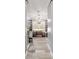 Hallway featuring wainscoting, wood-look tile, bench and a glimpse of the decorated walk-in shower at 5484 Sw 30Th Ave, Ocala, FL 34471