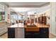 Open-concept kitchen features an island with copper sink overlooking the living room at 5484 Sw 30Th Ave, Ocala, FL 34471