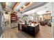 Open floor plan kitchen features an island, wood beams, and stainless appliances at 5484 Sw 30Th Ave, Ocala, FL 34471