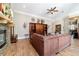 Cozy living room with hardwood floors, stone fireplace, and decorative wall accents at 5484 Sw 30Th Ave, Ocala, FL 34471