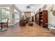 Spacious living room with a stone fireplace, wood floors, and natural light at 5484 Sw 30Th Ave, Ocala, FL 34471