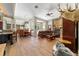 Open-concept living room featuring a fireplace, wood floors, and a dining area at 5484 Sw 30Th Ave, Ocala, FL 34471