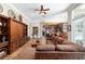 Spacious living room featuring hardwood floors, decorative built-ins, and large sectional sofa at 5484 Sw 30Th Ave, Ocala, FL 34471
