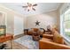 Bright living room with leather seating, a ceiling fan, and hardwood flooring at 5484 Sw 30Th Ave, Ocala, FL 34471