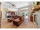 Open living space showcasing wood floors, fireplace, and adjacent kitchen and dining areas at 5484 Sw 30Th Ave, Ocala, FL 34471