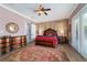 Primary bedroom with a ceiling fan, ensuite bath, and barn door to the closet at 5484 Sw 30Th Ave, Ocala, FL 34471