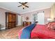 Main bedroom suite features a ceiling fan, an ensuite bath, and wood floors at 5484 Sw 30Th Ave, Ocala, FL 34471