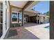 Inviting outdoor patio area featuring brick pavers, large windows, covered seating, and pool access at 5484 Sw 30Th Ave, Ocala, FL 34471