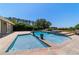 Tranquil backyard pool with a sun shelf, water feature, clear blue water, and well-maintained landscaping at 5484 Sw 30Th Ave, Ocala, FL 34471