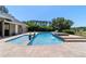 Backyard pool with an attached hot tub and patio with lounge chairs at 5484 Sw 30Th Ave, Ocala, FL 34471