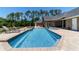 Backyard pool with attached hot tub and lounge chairs, with home exterior in the background at 5484 Sw 30Th Ave, Ocala, FL 34471