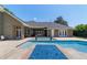 Gorgeous backyard pool featuring a sun shelf, blue mosaic accent, and seamless integration with the home's design at 5484 Sw 30Th Ave, Ocala, FL 34471
