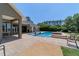 Backyard pool with a covered patio and dining table near the neutral colored single-story home at 5484 Sw 30Th Ave, Ocala, FL 34471