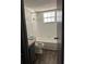 Bright bathroom featuring a shower-tub combination, tiled walls, and wood-look flooring at 571 Midway Trak # J202, Ocala, FL 34472