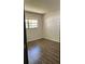Bedroom with window and dark wood floors at 571 Midway Trak # J202, Ocala, FL 34472