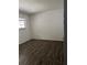 Bedroom with window and dark wood floors at 571 Midway Trak # J202, Ocala, FL 34472