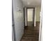 Condo entryway featuring modern dark wood floors and a view into the main living area at 571 Midway Trak # J202, Ocala, FL 34472