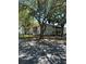 Two-story condo building with mature trees and a wood fence in a serene community at 571 Midway Trak # J202, Ocala, FL 34472