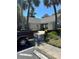View of the community clubhouse with well-maintained landscaping and ample parking at 571 Midway Trak # J202, Ocala, FL 34472