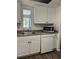 Updated kitchen featuring white cabinets, laminate countertops, and stainless steel appliances at 571 Midway Trak # J202, Ocala, FL 34472
