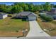 Aerial view of the single-story home, showcasing the lawn and driveway at 5899 Pecan Rd, Ocala, FL 34472
