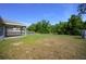 Large grassy backyard with trees, perfect for outdoor activities and enjoying nature at 5899 Pecan Rd, Ocala, FL 34472