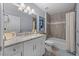 Bathroom features double sink vanity, granite counters, a tub, and wood look flooring at 5899 Pecan Rd, Ocala, FL 34472