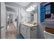 Bright bathroom featuring granite countertops, decor, and wood-look tile flooring at 5899 Pecan Rd, Ocala, FL 34472