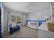 Bedroom features blue accent walls, a white crib and a comfortable rocking chair at 5899 Pecan Rd, Ocala, FL 34472