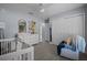 Bedroom features carpeted floor, a white crib, and closet storage space at 5899 Pecan Rd, Ocala, FL 34472