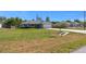 Single-story home featuring a lush, green front yard and a paved driveway at 5899 Pecan Rd, Ocala, FL 34472